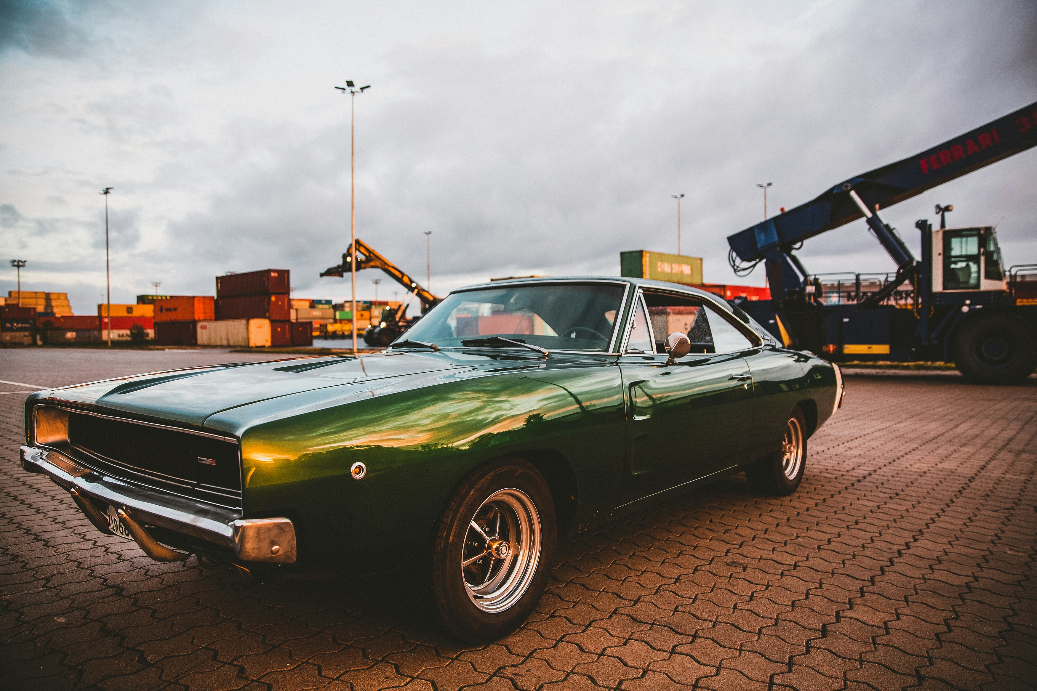 green chevrolet camaro parked on parking lot during daytime